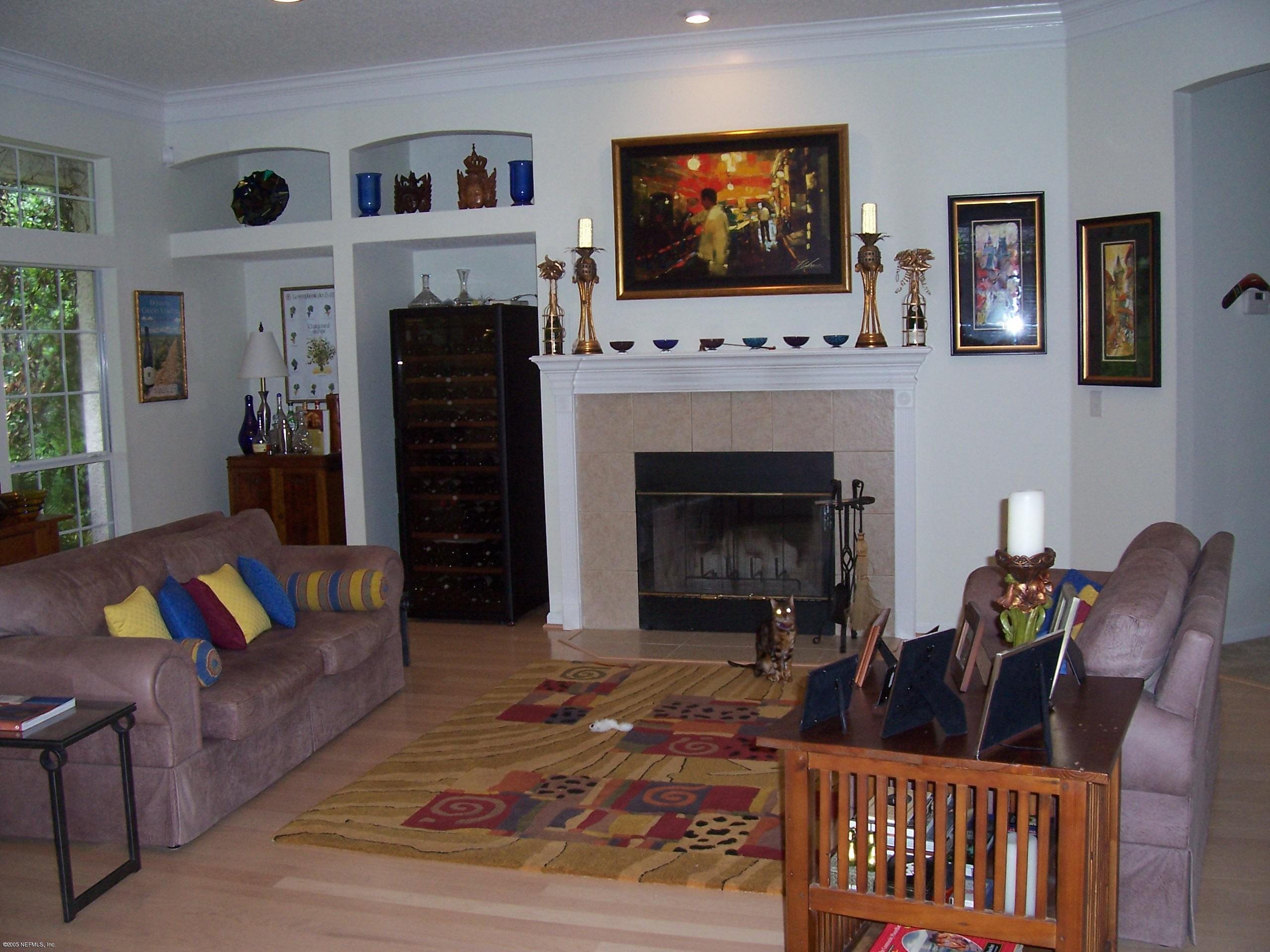 841 Mill Stream Road Ponte Vedra Beach, FL 32082 - Photo 2 of 7 a living room with furniture a flat screen tv and a fireplace