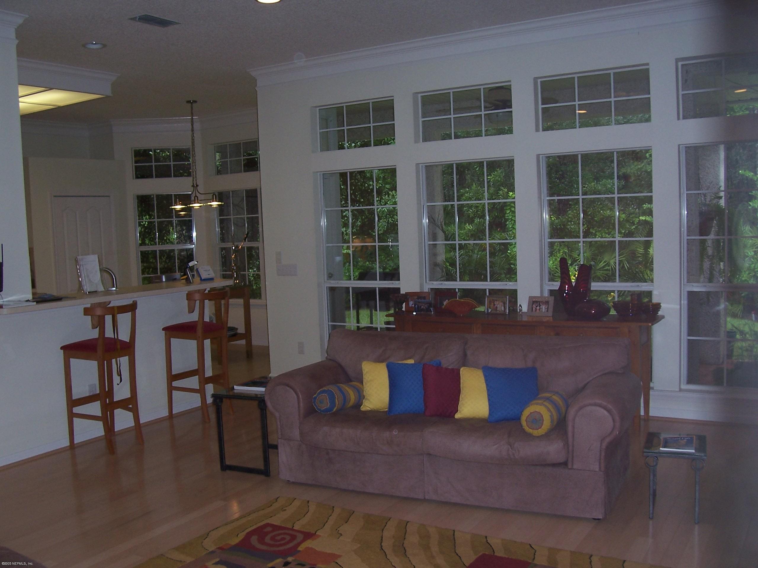 841 Mill Stream Road Ponte Vedra Beach, FL 32082 - Photo 3 of 7 a living room with furniture and floor to ceiling window
