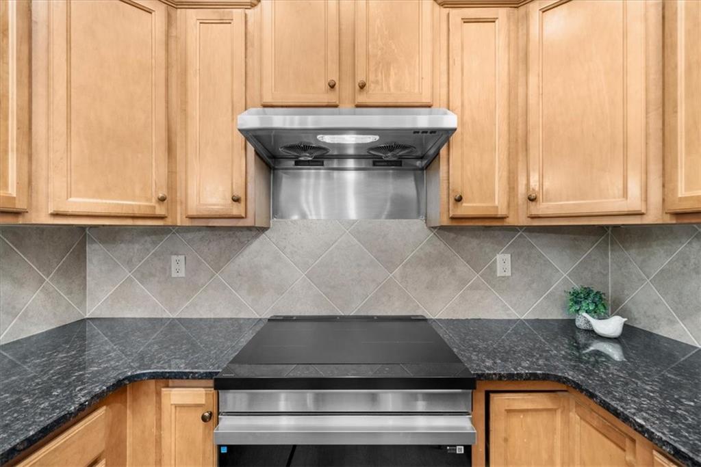 2735 Gateview Court Cumming, GA 30040 - Photo 12 of 35 a kitchen with granite countertop a sink and a stove