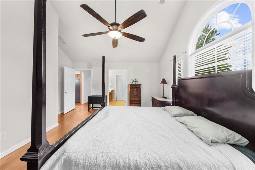 2735 Gateview Court Cumming, GA 30040 - Photo 21 of 35 a bedroom with a large bed and a chandelier