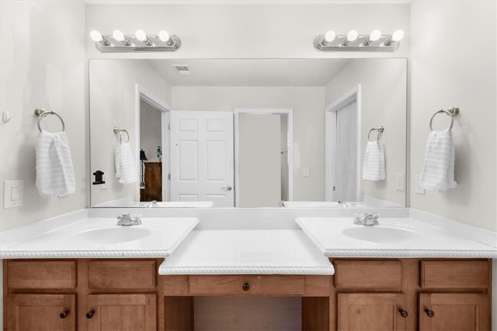 2735 Gateview Court Cumming, GA 30040 - Photo 22 of 35 a bathroom with a sink vanity and a mirror
