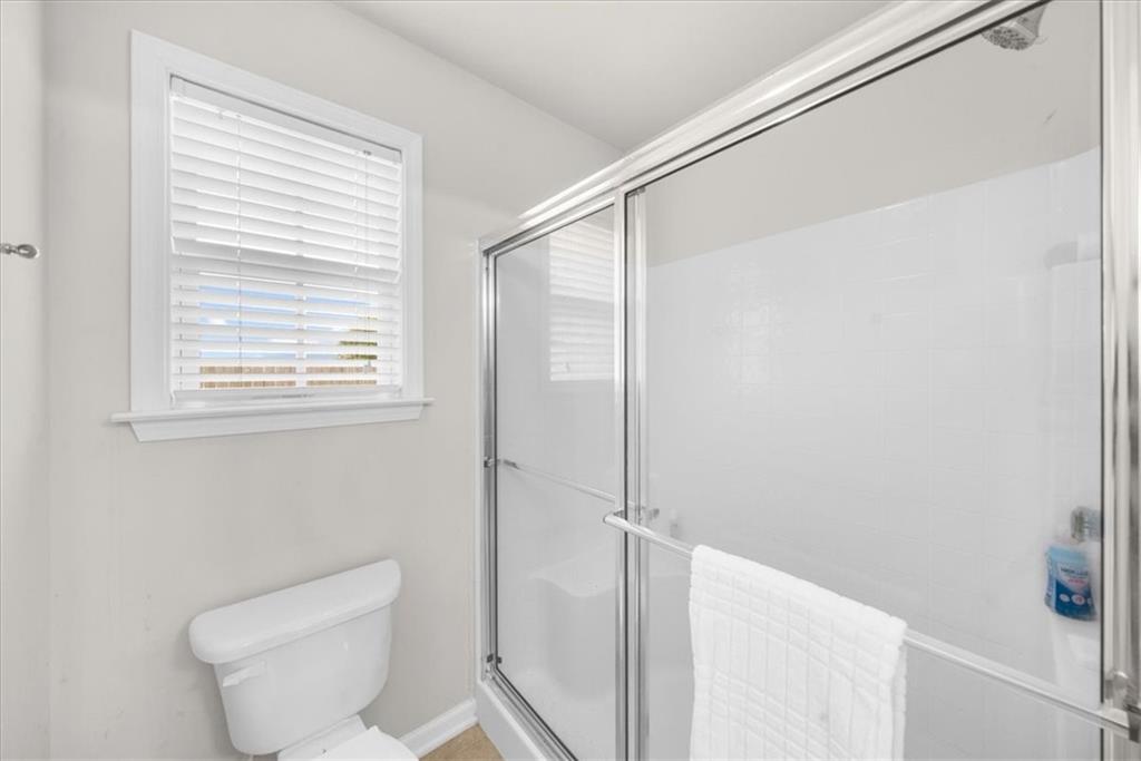 2735 Gateview Court Cumming, GA 30040 - Photo 23 of 35 a bathroom with a toilet and a shower