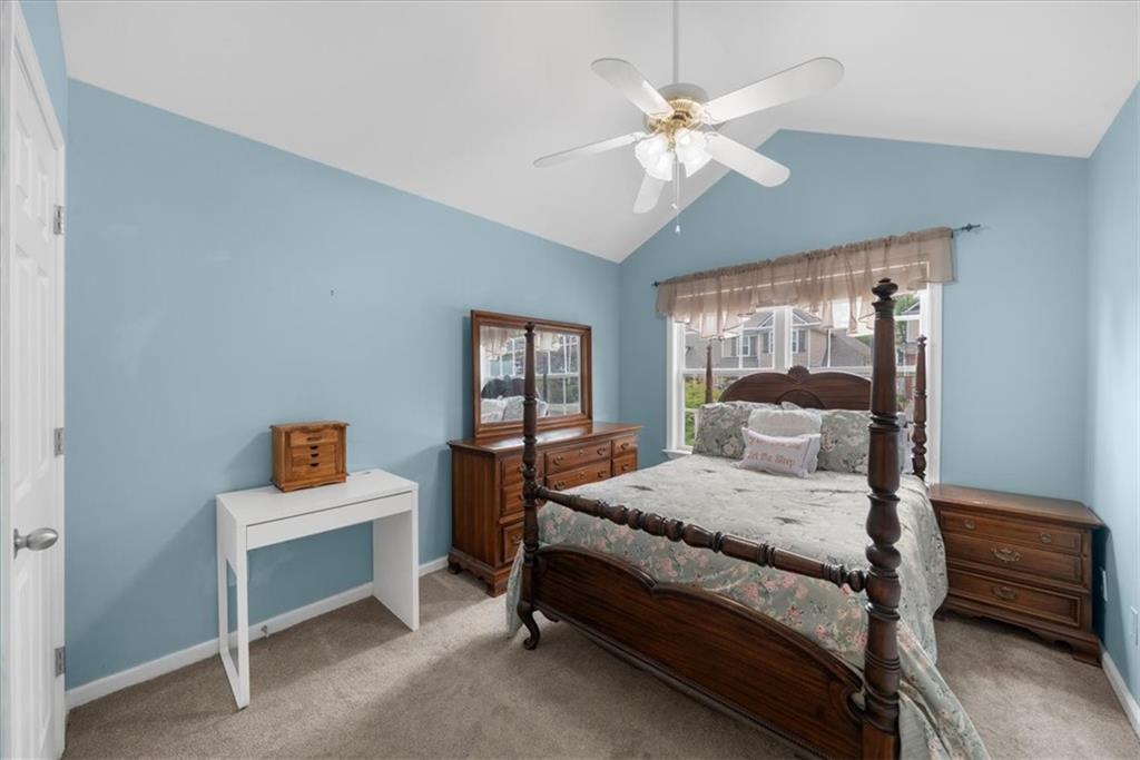 2735 Gateview Court Cumming, GA 30040 - Photo 25 of 35 a bedroom with a bed and a chandelier