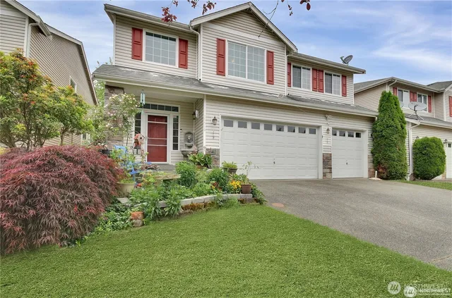 a front view of a house with a yard and garage