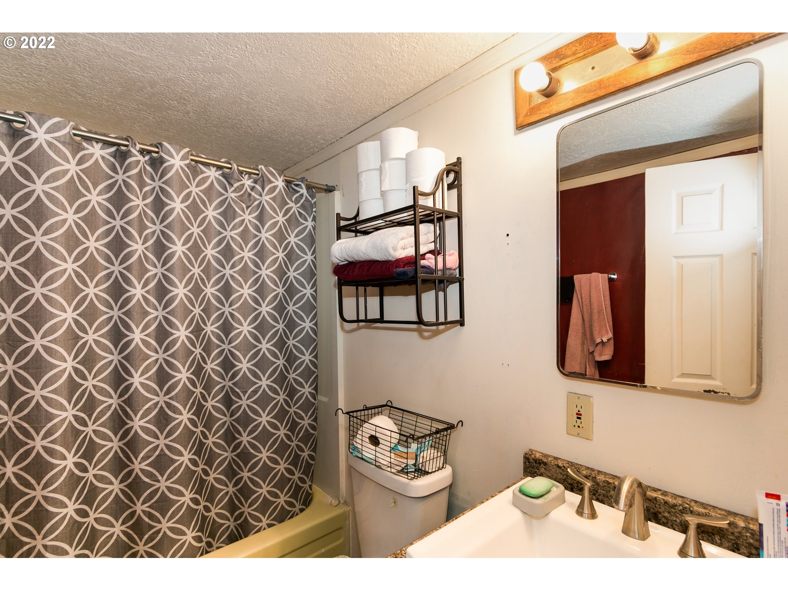 3724 E Street Springfield, OR 97478 - Photo 11 of 16 a bathroom with a sink toilet and mirror