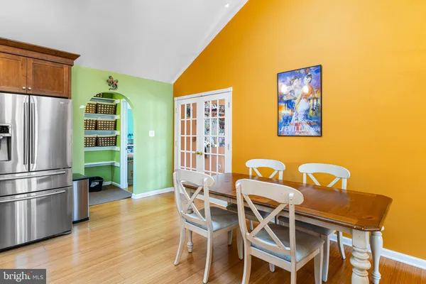 a view of a dining room with furniture and a kitchen