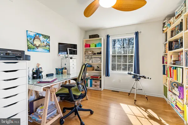 a work room with furniture and a bookshelf