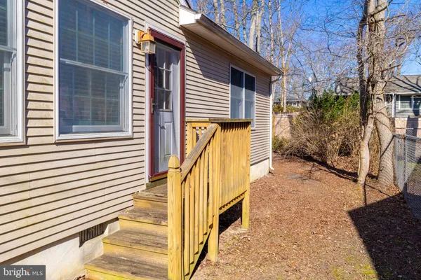 a view of a house with wooden fence