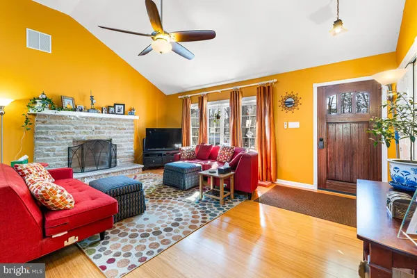 a living room with furniture a fireplace and a flat screen tv