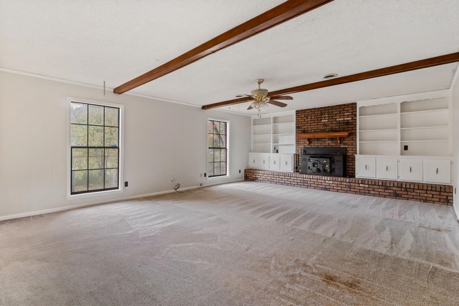 5034 Quince Road Memphis, TN 38117 - Photo 12 of 25 an empty room with windows and fireplace