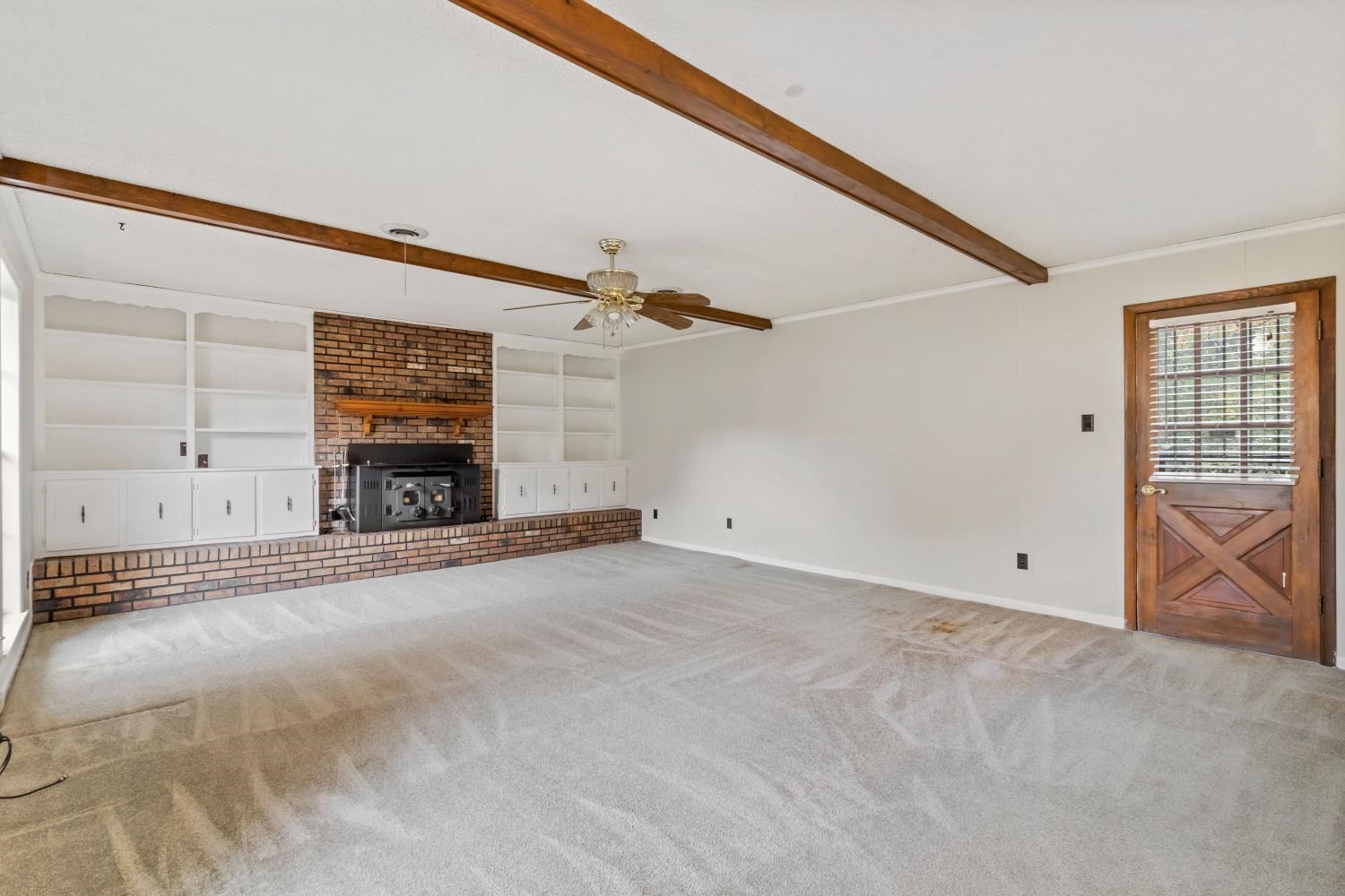 5034 Quince Road Memphis, TN 38117 - Photo 13 of 25 a view of empty room with fireplace and windows