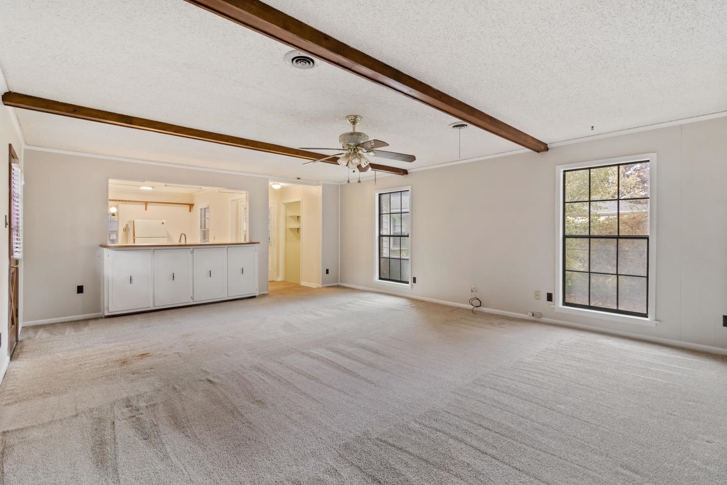 5034 Quince Road Memphis, TN 38117 - Photo 14 of 25 an empty room with windows and ceiling fan