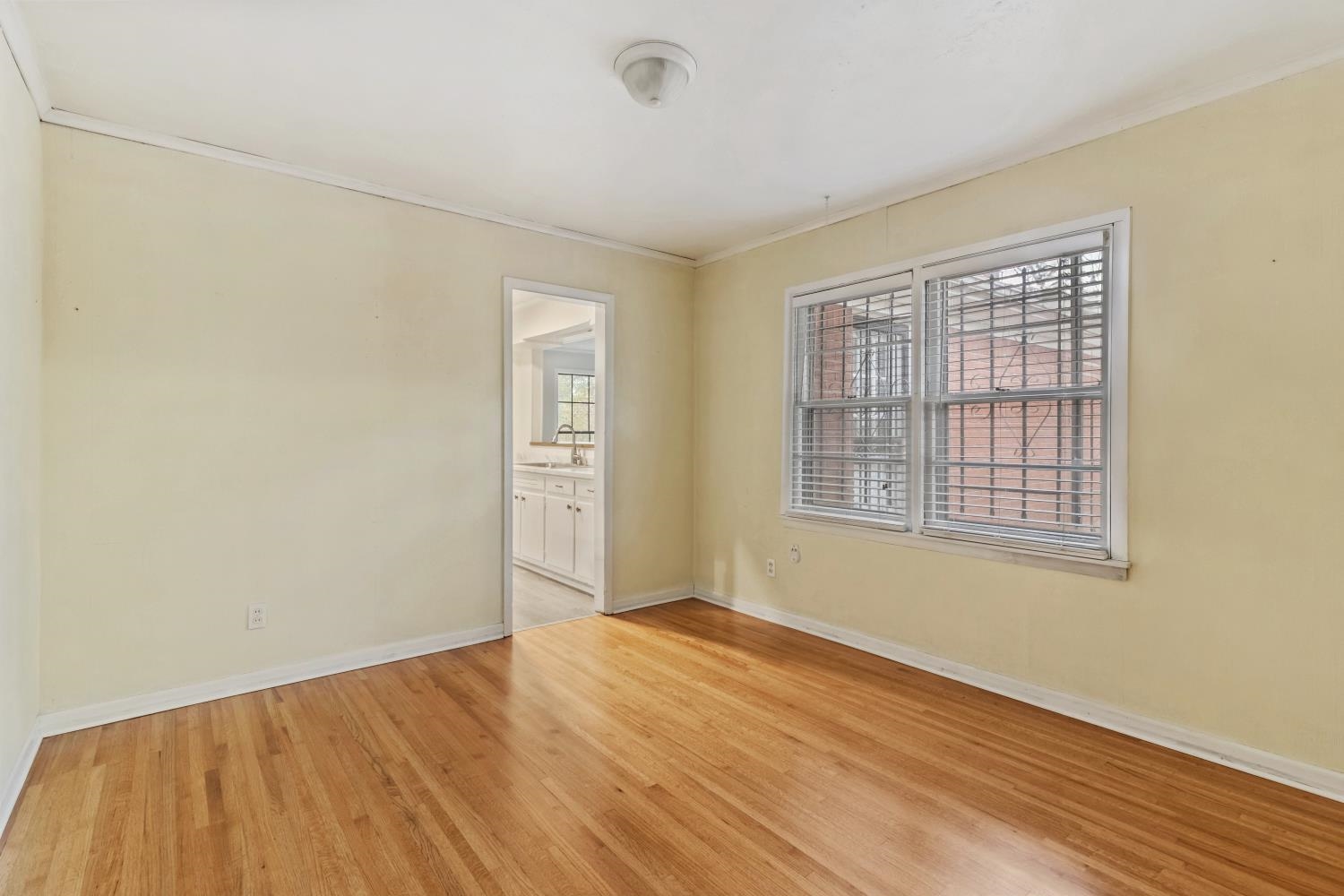 5034 Quince Road Memphis, TN 38117 - Photo 16 of 25 a view of an empty room with wooden floor and a window