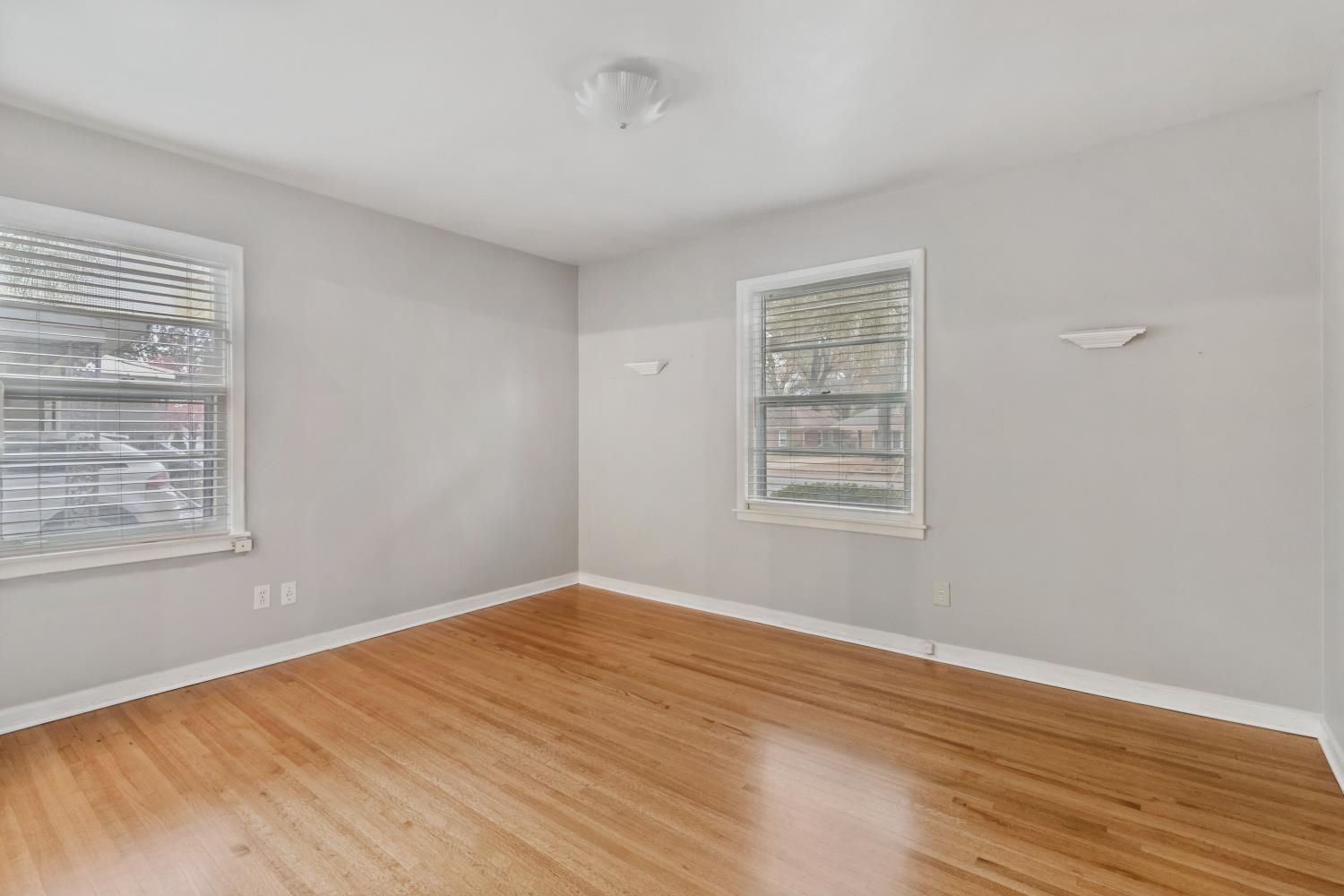 5034 Quince Road Memphis, TN 38117 - Photo 17 of 25 a view of an empty room with wooden floor and a window