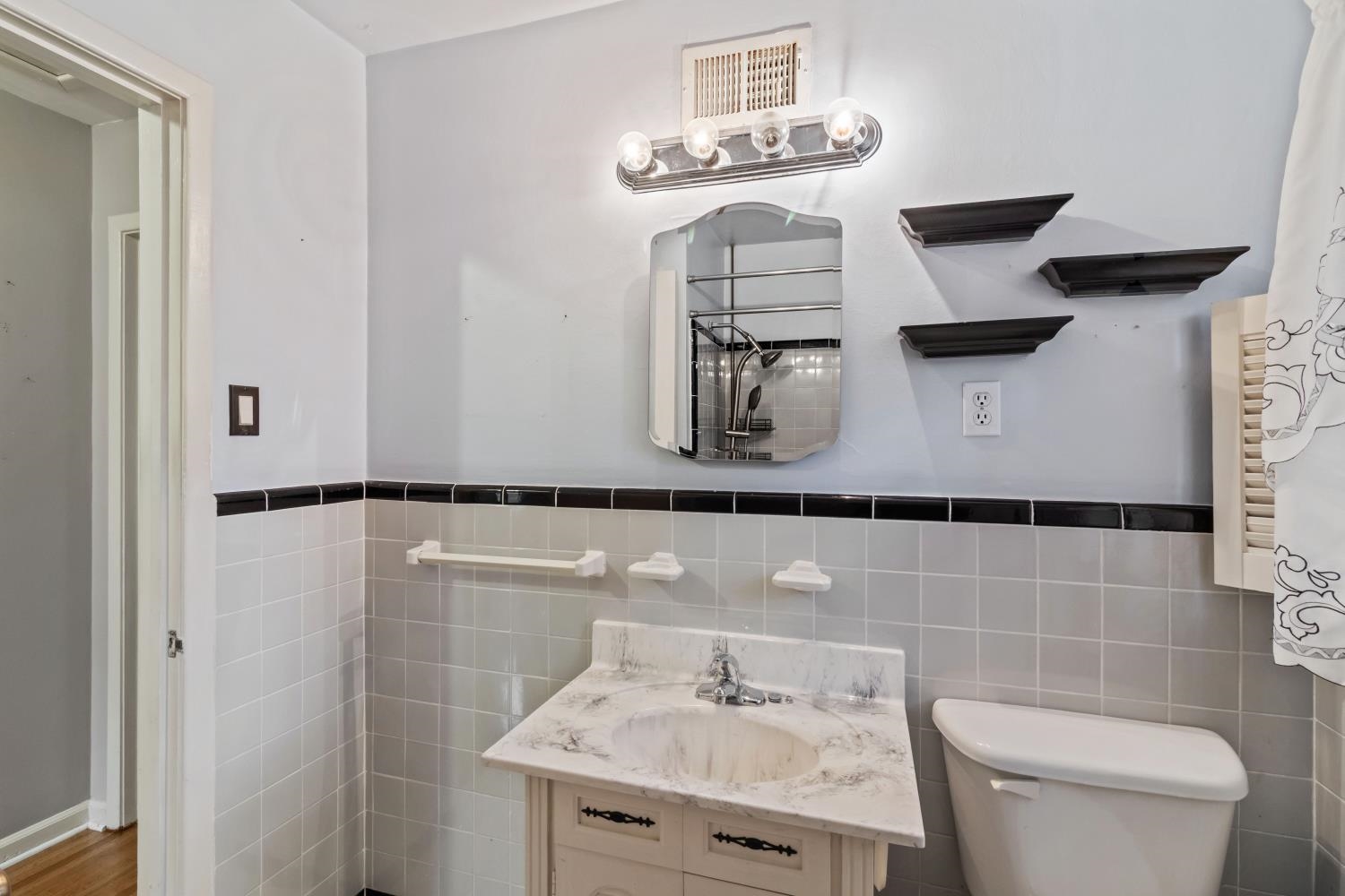 5034 Quince Road Memphis, TN 38117 - Photo 22 of 25 a bathroom with a sink toilet and mirror