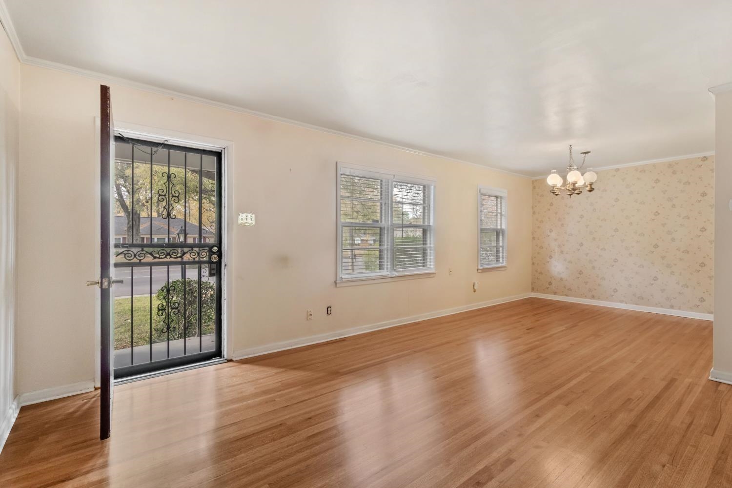 5034 Quince Road Memphis, TN 38117 - Photo 4 of 25 an empty room with wooden floor and windows