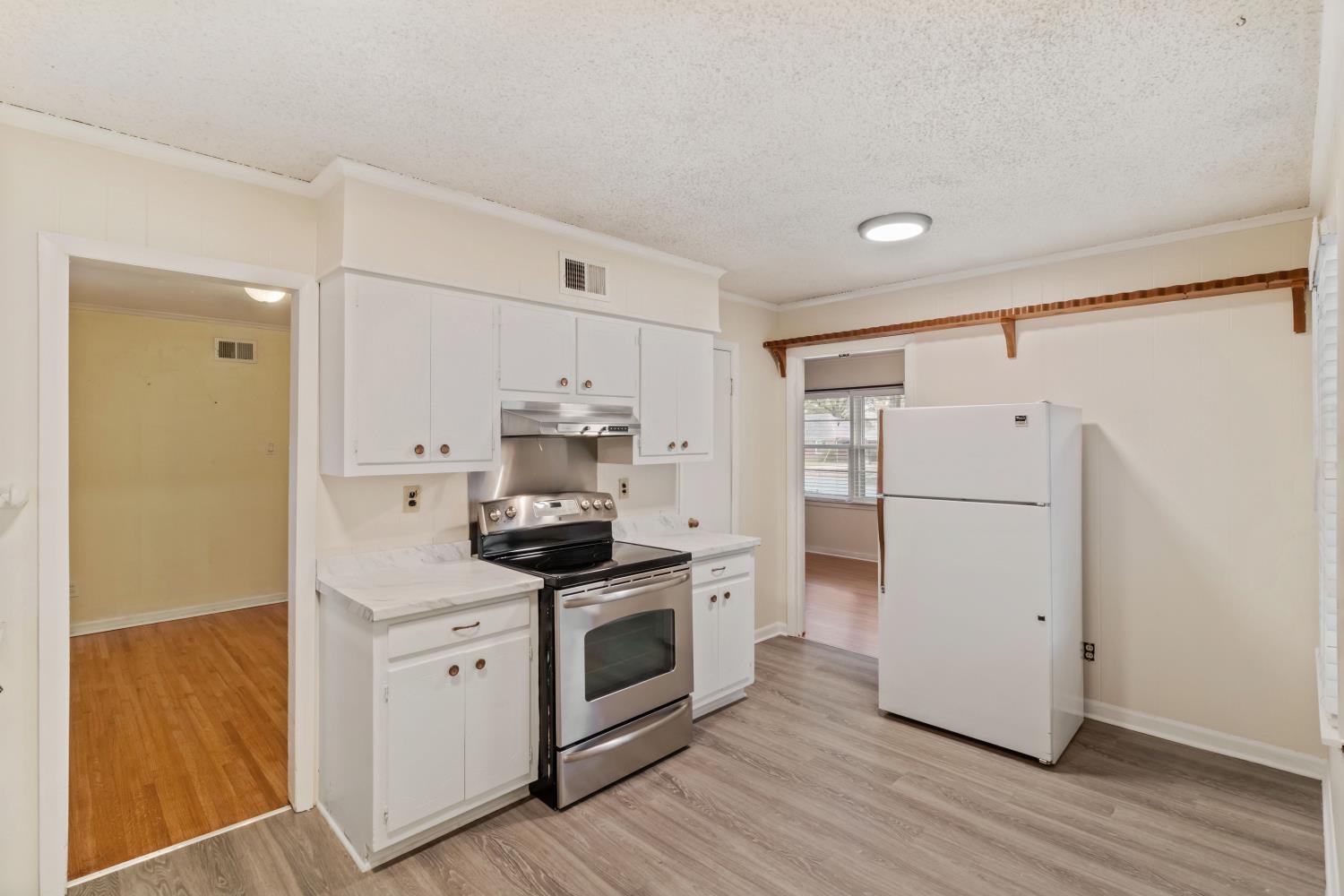 5034 Quince Road Memphis, TN 38117 - Photo 9 of 25 a kitchen with white cabinets and white appliances