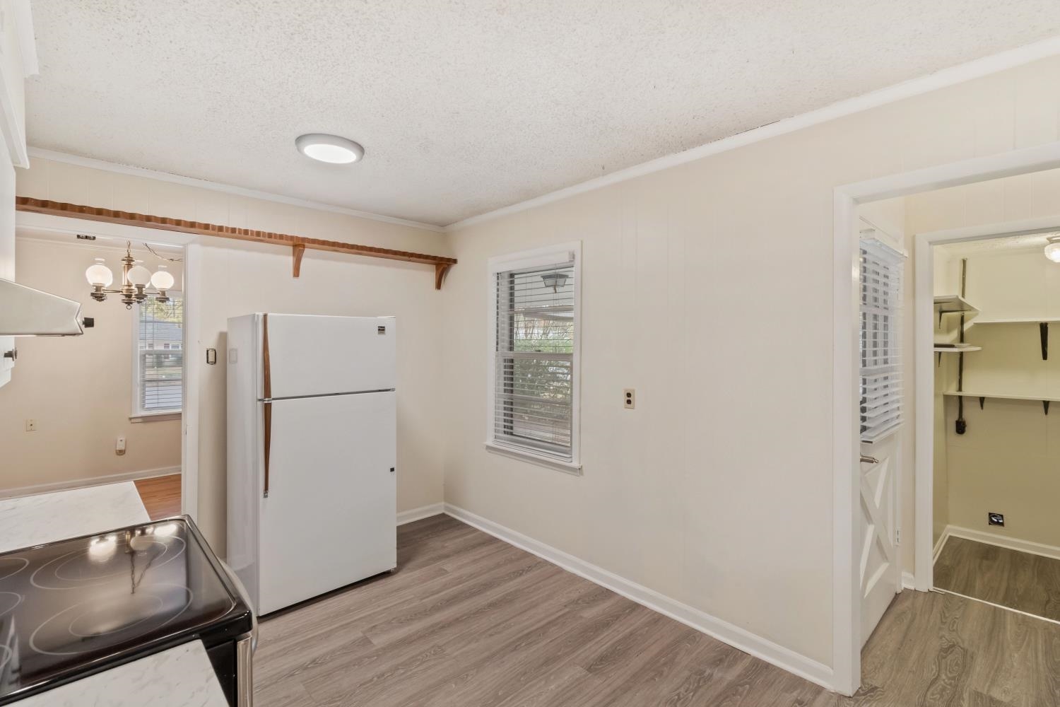 5034 Quince Road Memphis, TN 38117 - Photo 10 of 25 a view of a kitchen with refrigerator and wooden floor