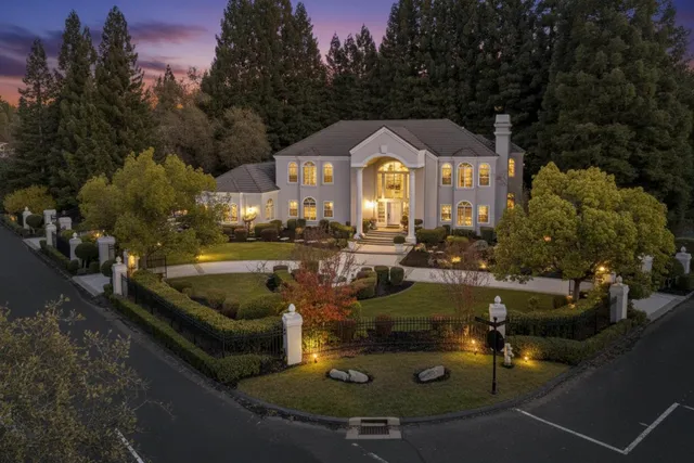 a view of a house with swimming pool and sitting area