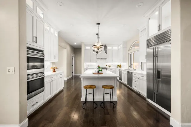 a kitchen with cabinets stainless steel appliances and a sink