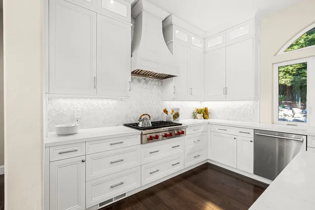 a bathroom with a granite countertop sink vanity mirror bathtub shower and a toilet