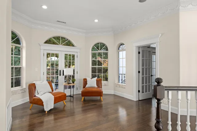 a living room with furniture large window and a flat screen tv