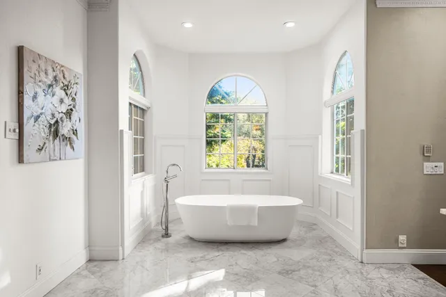 a view of a house with a small yard and a fountain