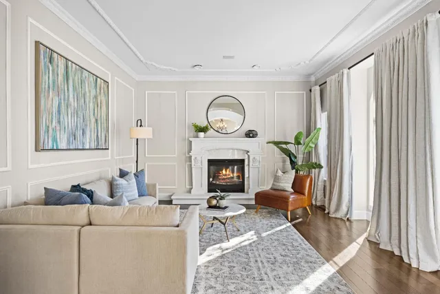 a dining room with wooden floor and a chandelier