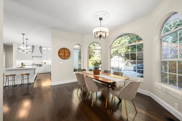 a kitchen with refrigerator cabinets and wooden floor