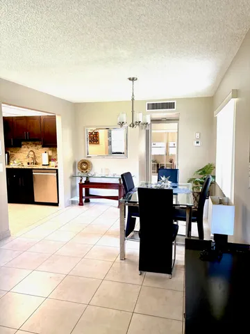 a view of a dining room with furniture and chandelier