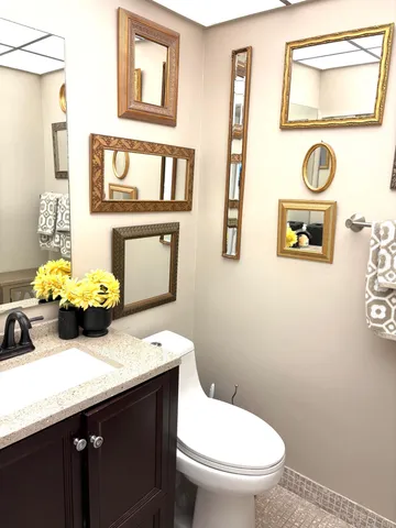 a bathroom with a toilet sink and mirror
