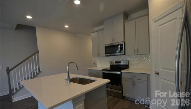 a kitchen with a sink and cabinets