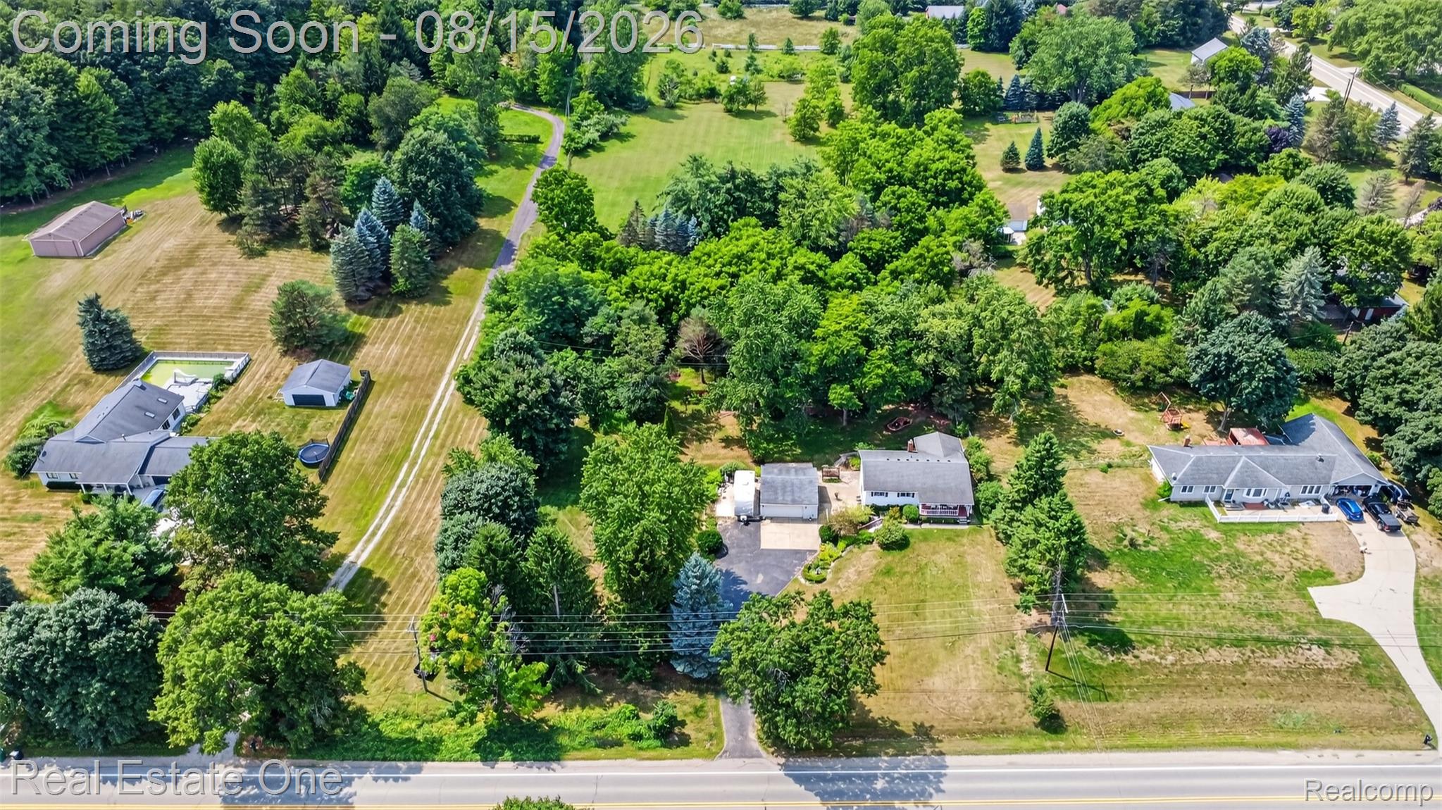 454 South Baldwin Road Oxford, MI 48371 - Photo 51 of 64 Expansive lot featuring mature trees, a driveway, and a detached building