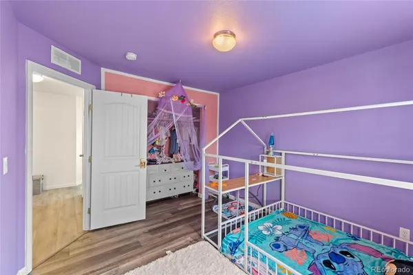 a bedroom with furniture and a baby crib