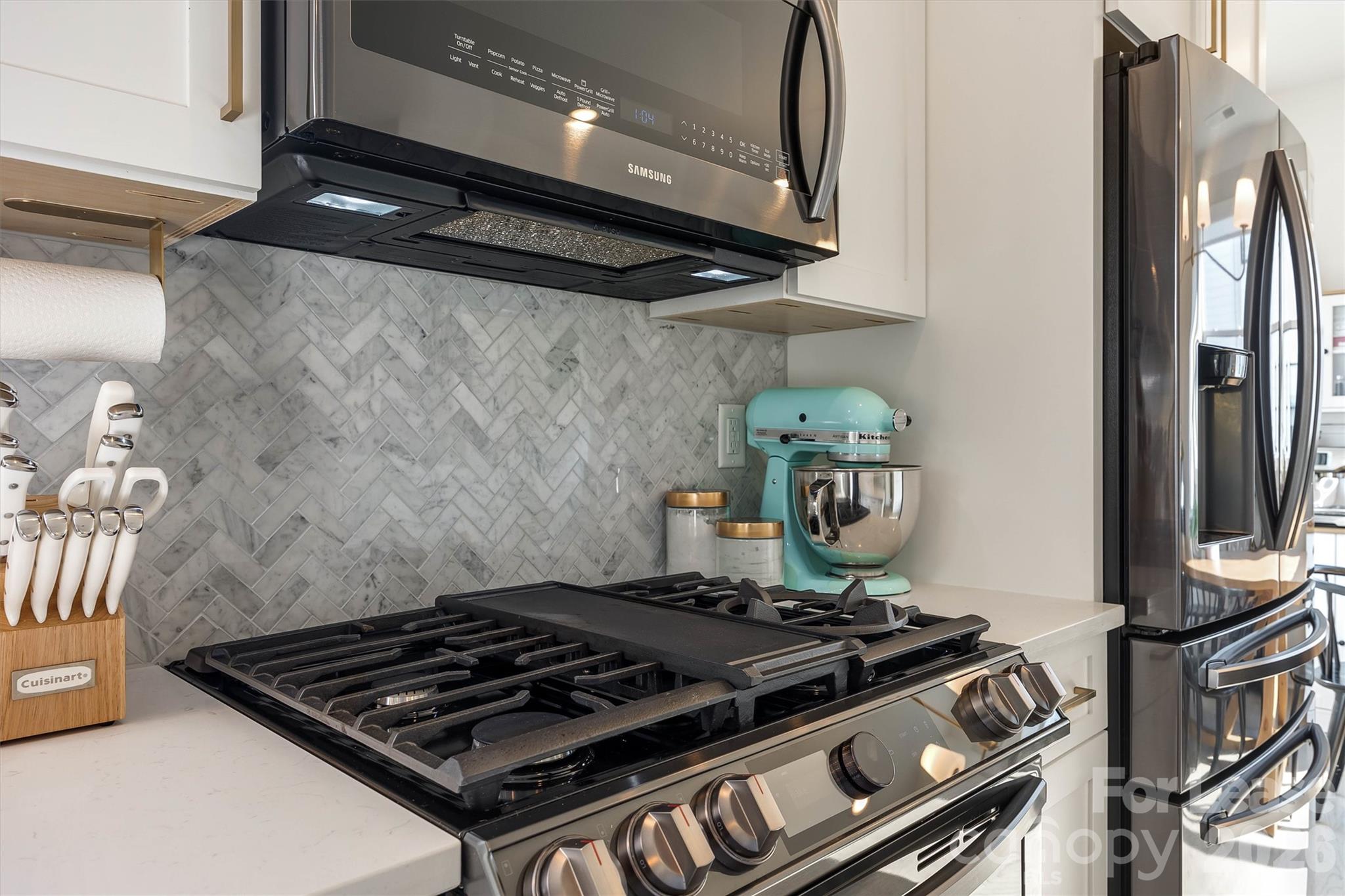 2319 Wesley Village Road Charlotte, NC 28208 - Photo 17 of 44 a stove top oven sitting inside of a kitchen