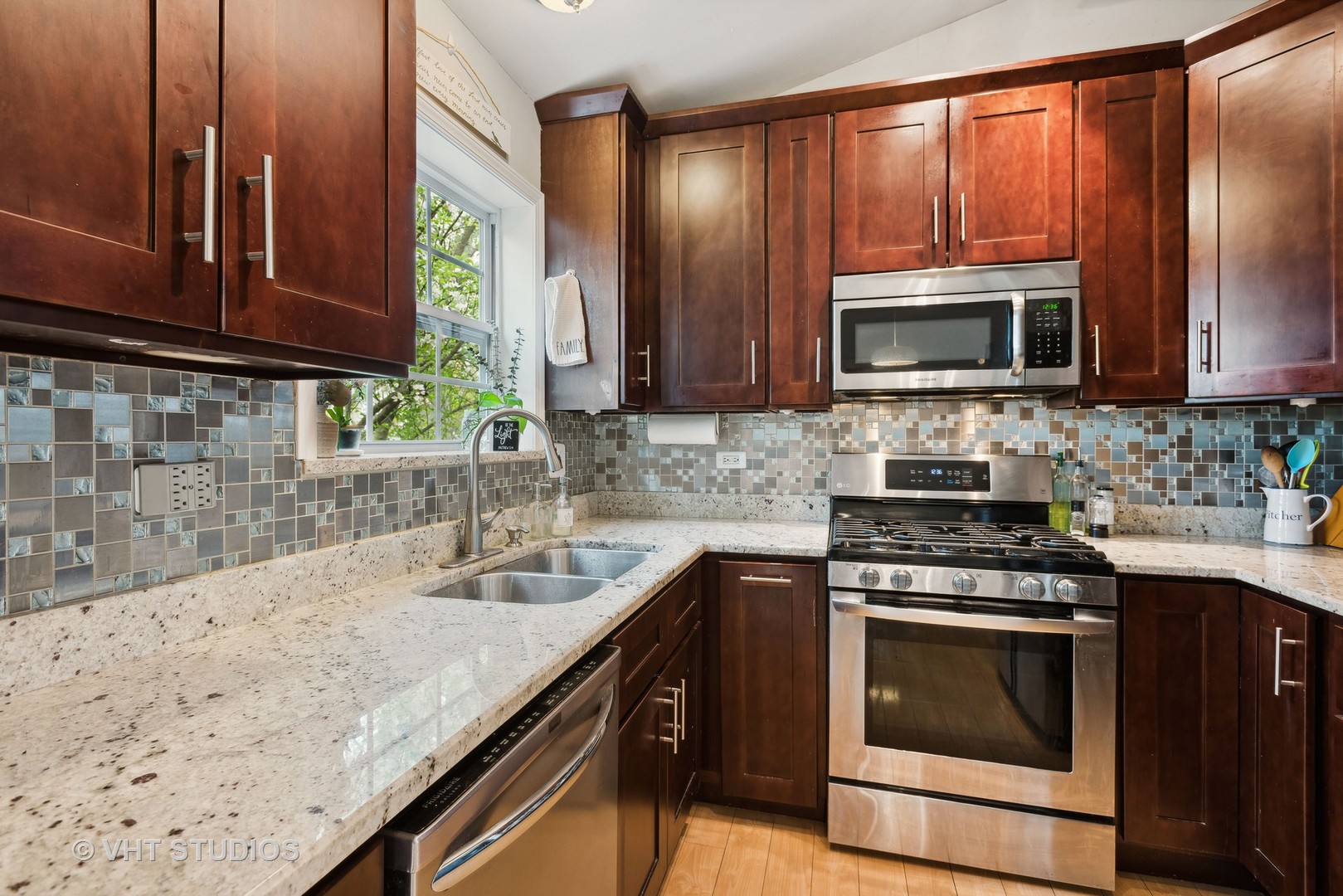 27W252 Churchill Road Winfield, IL 60190 - Photo 4 of 18 a kitchen with granite countertop wooden cabinets stainless steel appliances and a sink