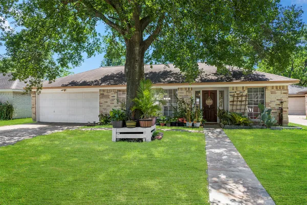a view of a house with a yard and sitting area