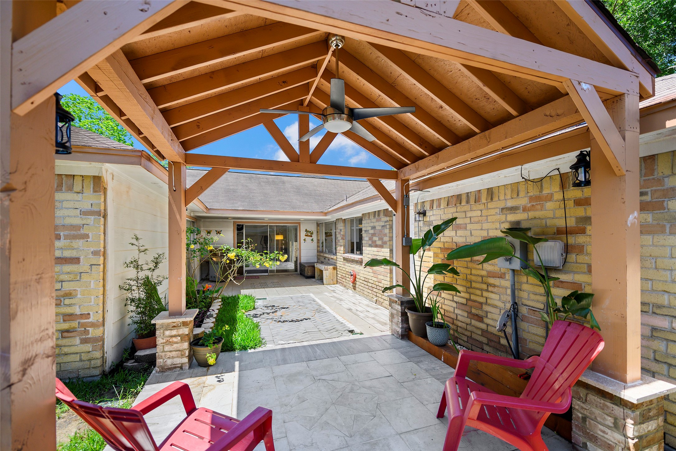 6815 River Mill Drive Spring, TX 77379 - Photo 23 of 33 a patio with a table and chairs and potted plants