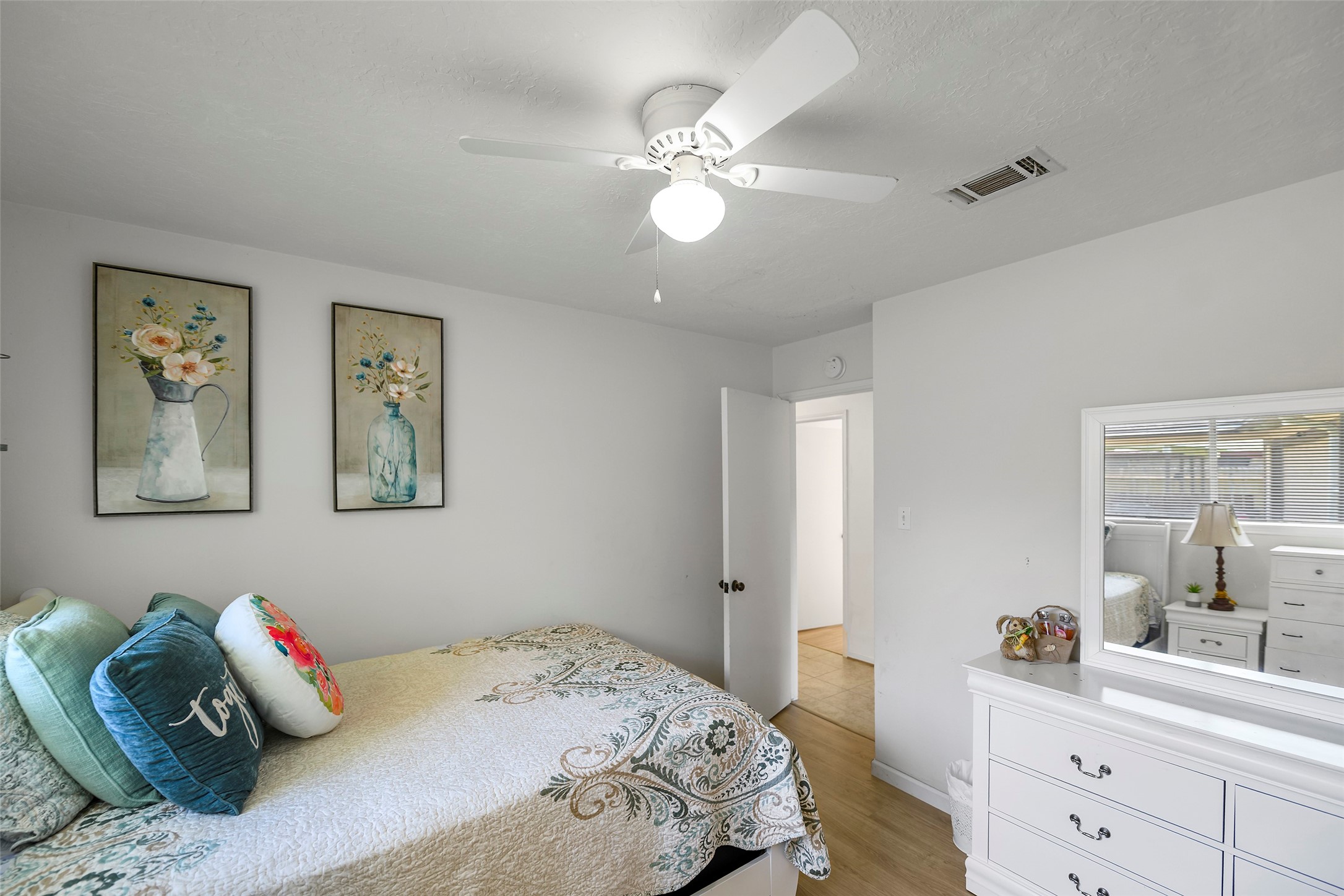 6815 River Mill Drive Spring, TX 77379 - Photo 25 of 33 a bedroom with a bed and a chandelier