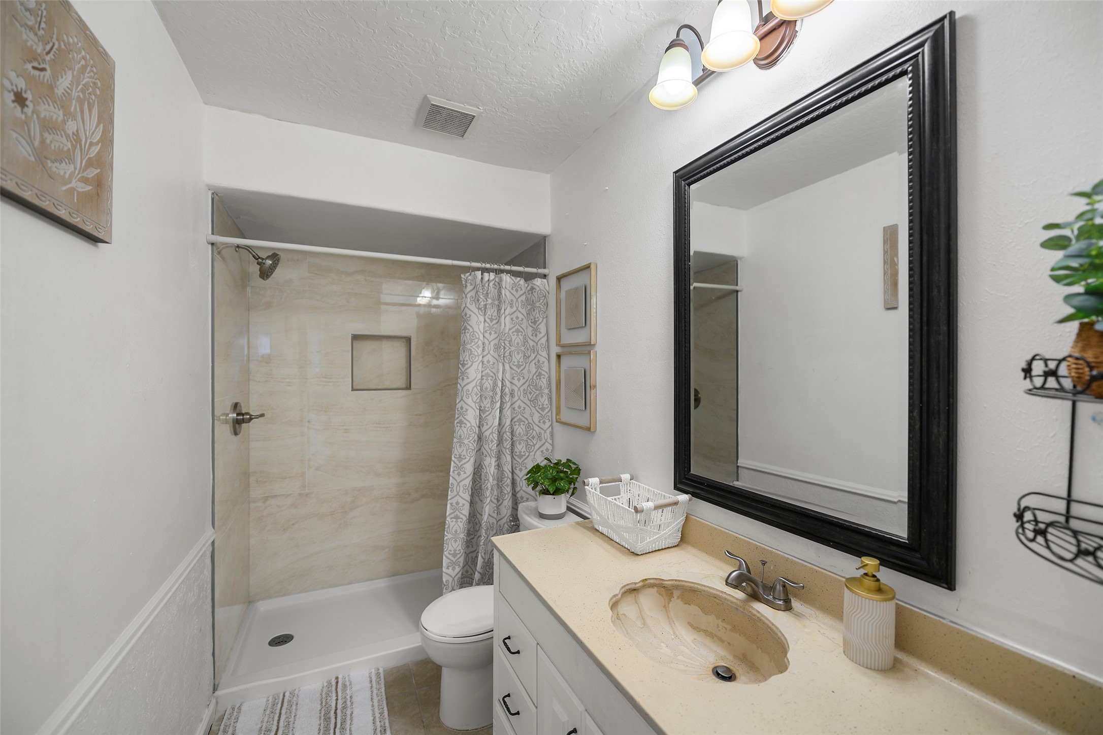 6815 River Mill Drive Spring, TX 77379 - Photo 26 of 33 a bathroom with a sink vanity granite toilet and shower