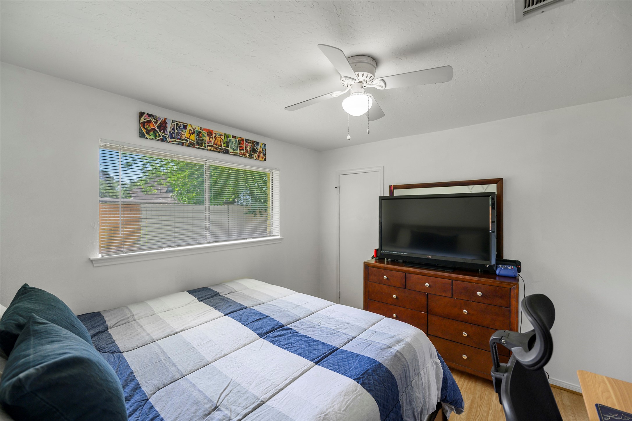 6815 River Mill Drive Spring, TX 77379 - Photo 27 of 33 a bedroom with a bed and a flat screen tv