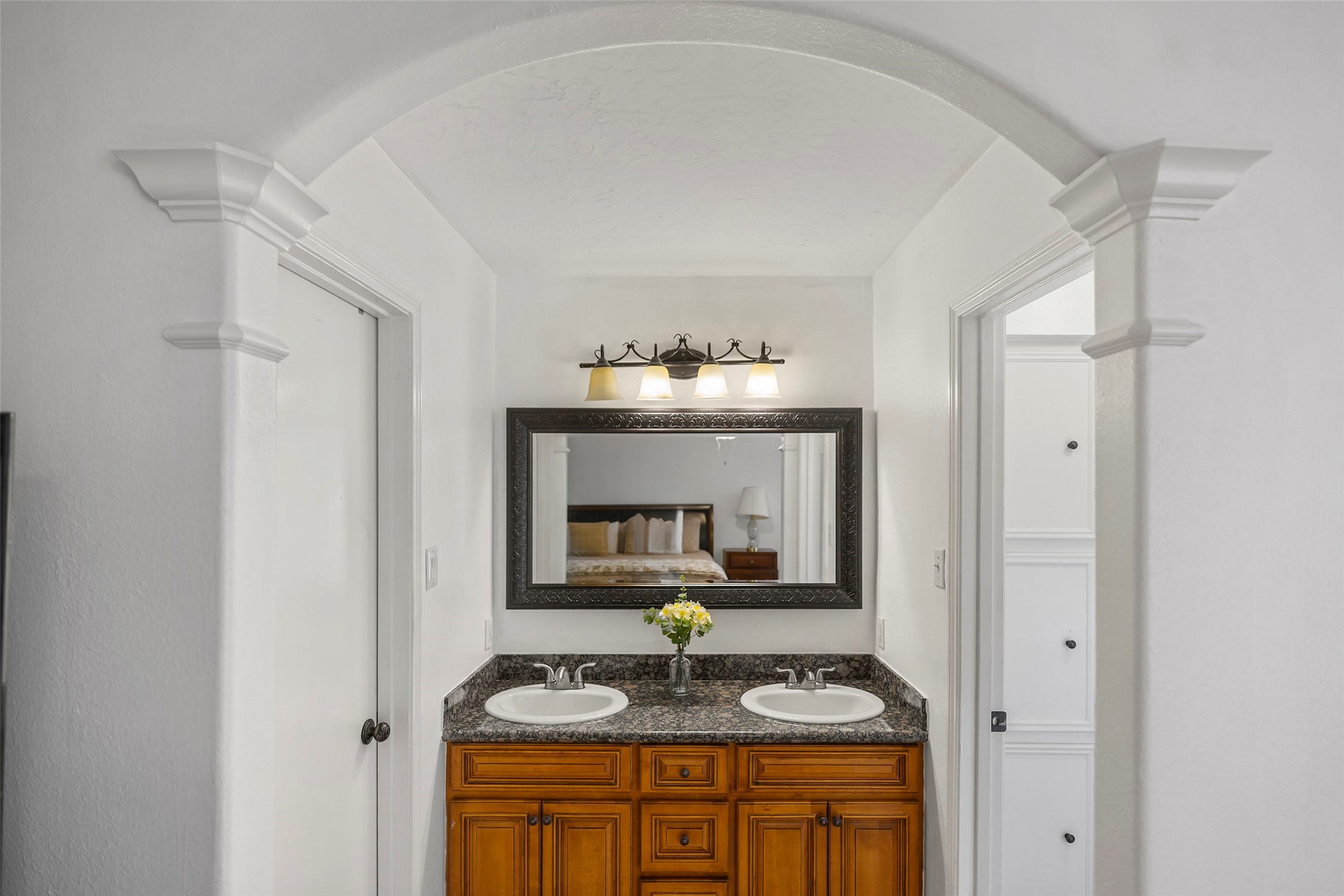 6815 River Mill Drive Spring, TX 77379 - Photo 31 of 33 a bathroom with a granite countertop sink and a mirror