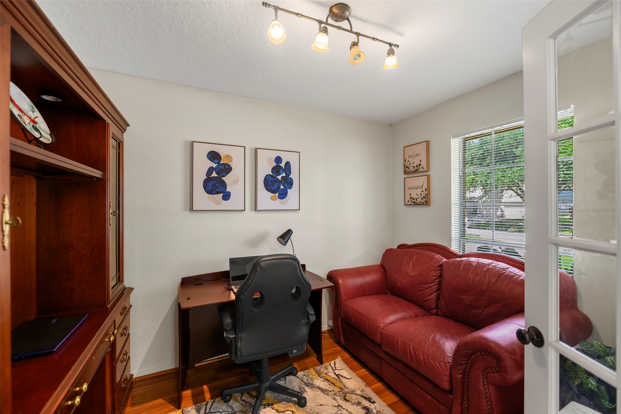 6815 River Mill Drive Spring, TX 77379 - Photo 4 of 33 a living room with furniture two windows and a flat screen tv