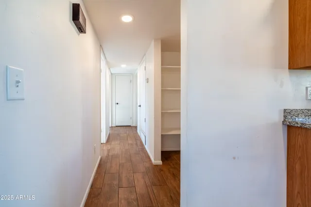 a view of a hallway with wooden floor