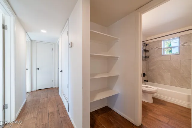 a bathroom with a toilet and a shower