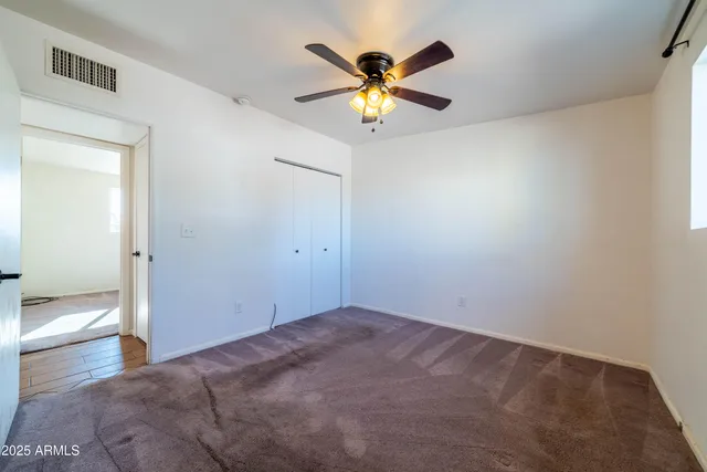 a view of a livingroom with a ceiling fan and window