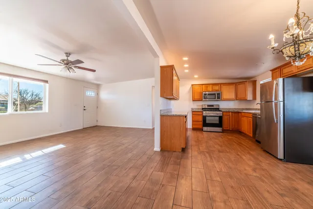 a view of kitchen with furniture wooden floor and window