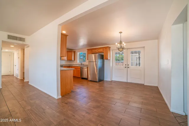 a view of a kitchen with a refrigerator a microwave and a sink