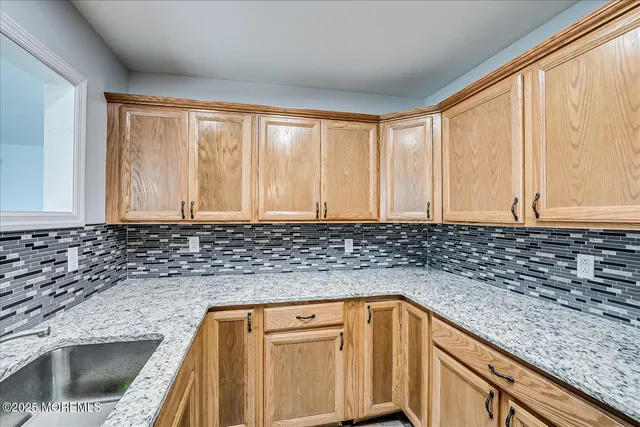 a kitchen with granite countertop a sink and a window