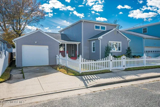 a front view of a house with a garden and yard